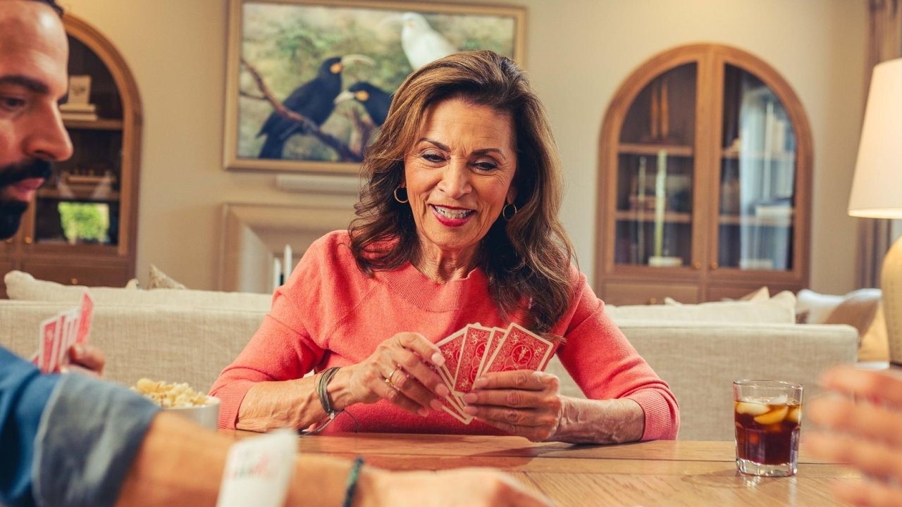 woman playing cards at a dining room table