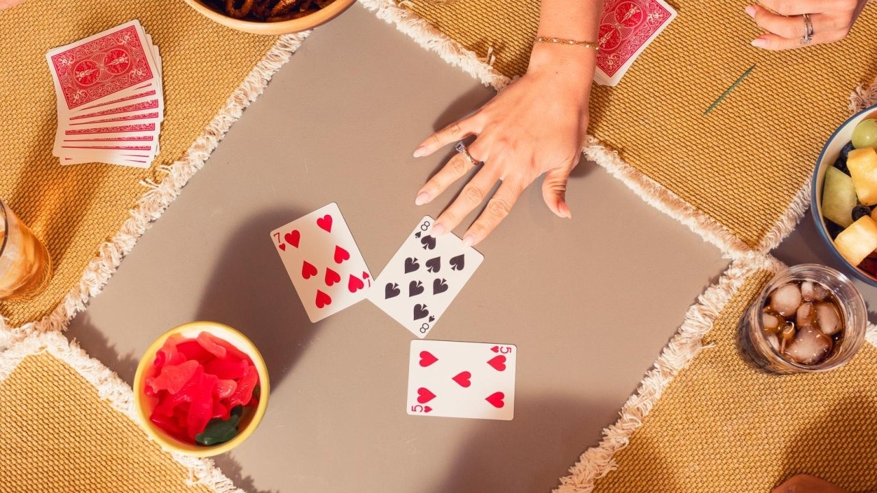rider back playing cards being played on a table with snacks